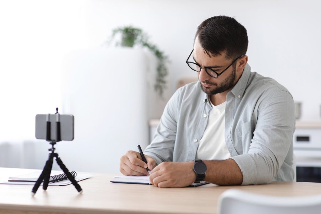 Busy middle aged caucasian man with beard in glasses study at home, listen online lesson or webinar